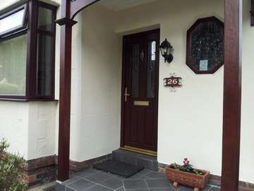 Miss F. Bebington. Installation of a Apeer 70 Triple Glazed Composite door Rosewood with Gold triple Glazed beveled Leaded units 